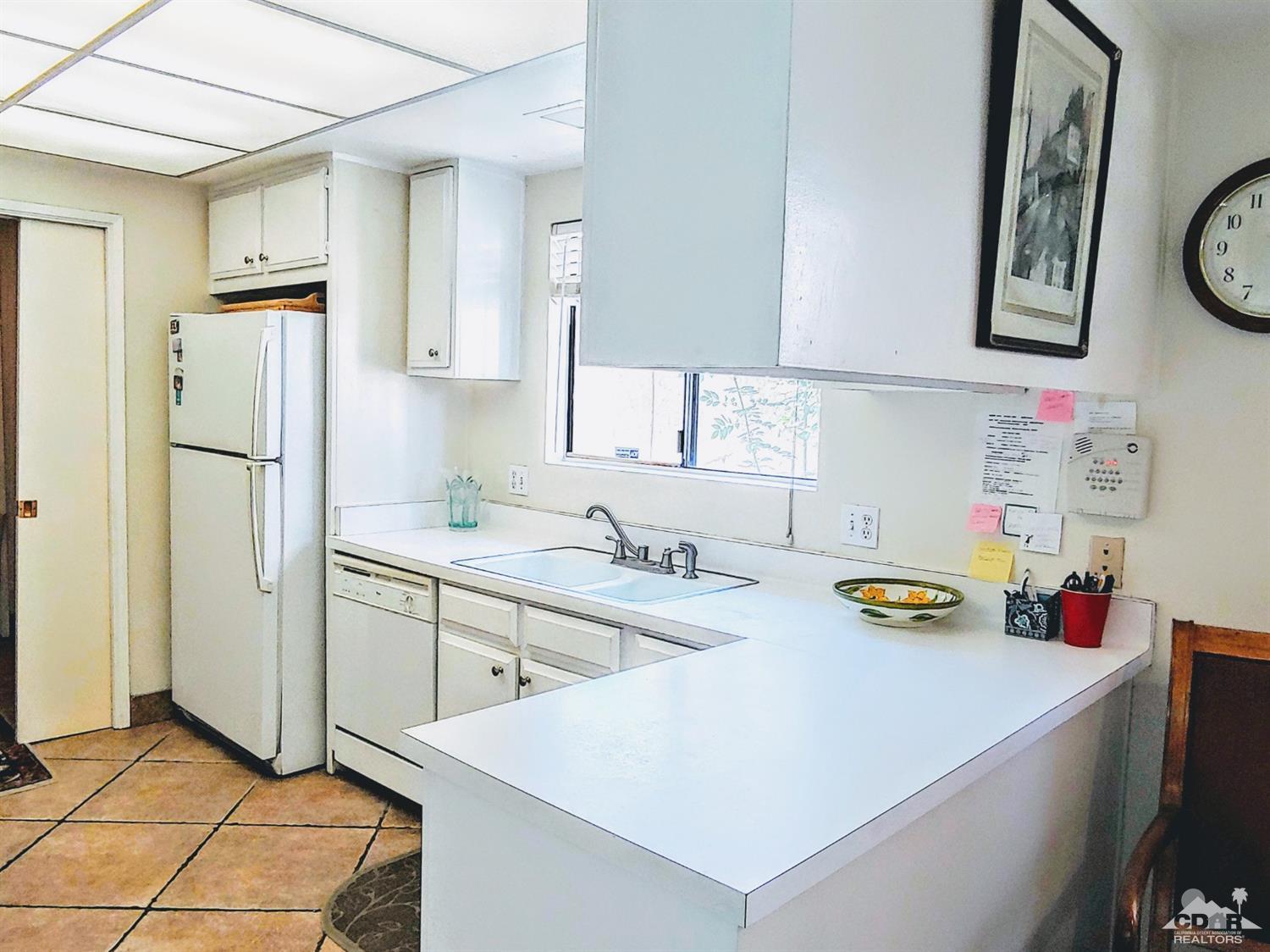 69940 Los Cocos Court Rancho Mirage, CA 92270 - Photo 11 of 37 a kitchen with a sink a stove and cabinets