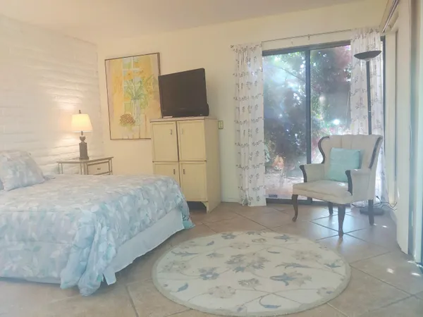 a bedroom with a bed and a chair