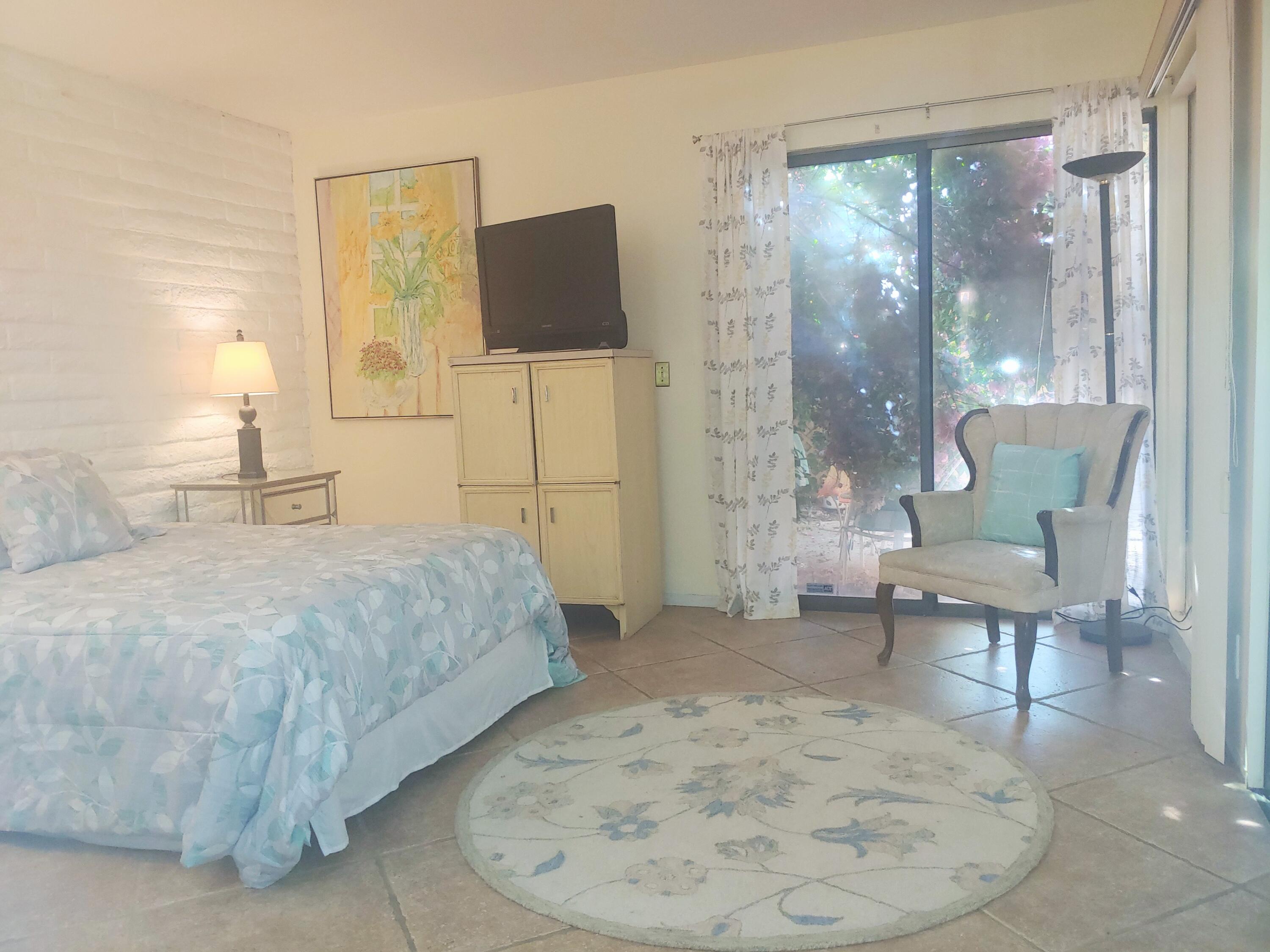 69940 Los Cocos Court Rancho Mirage, CA 92270 - Photo 13 of 37 a bedroom with a bed and a chair