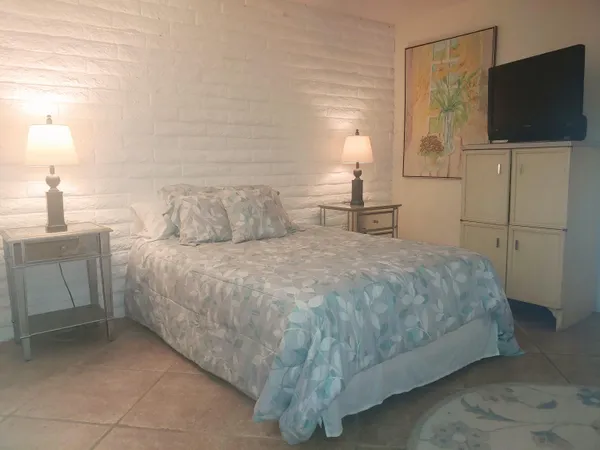 a bedroom with a bed and a flat screen tv