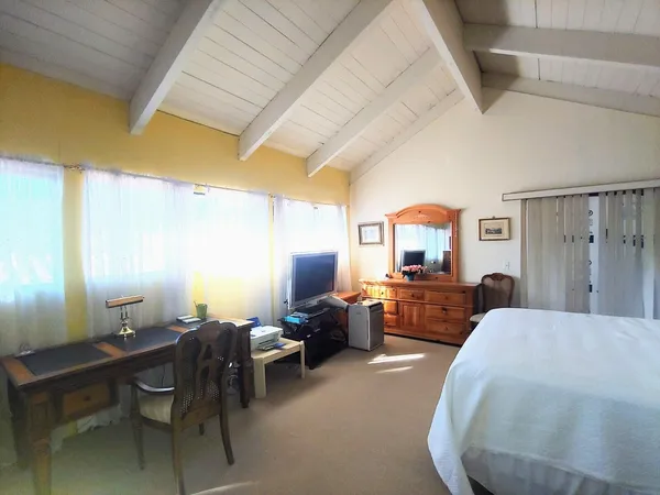a bedroom with furniture and a wooden floor