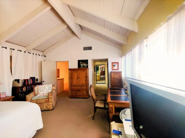 a bedroom with furniture and a window
