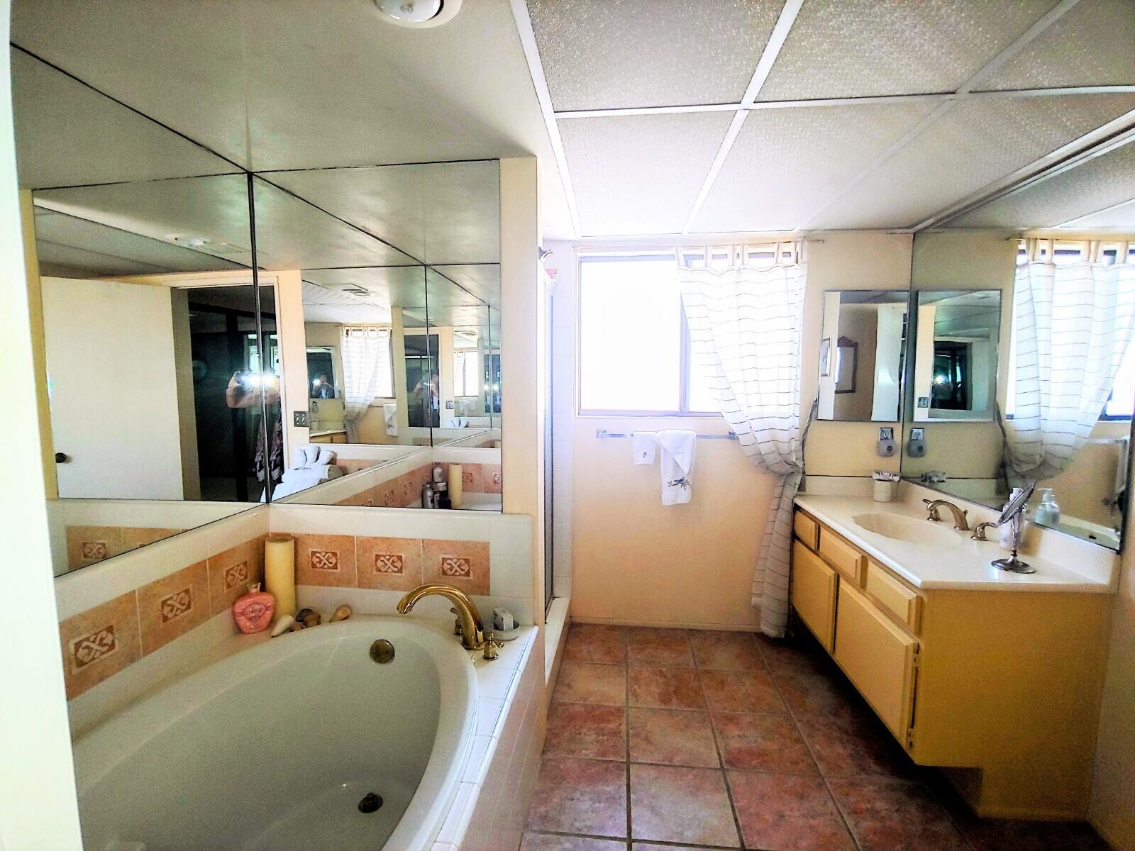 69940 Los Cocos Court Rancho Mirage, CA 92270 - Photo 27 of 37 a bathroom with a tub sink and mirror