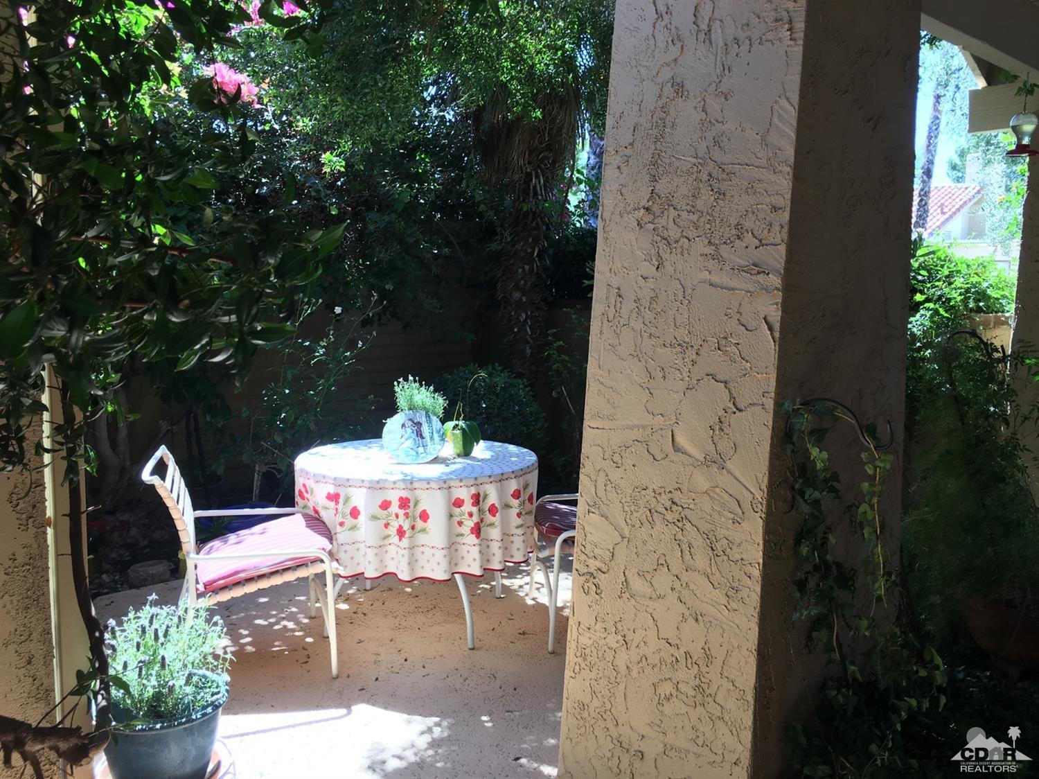 69940 Los Cocos Court Rancho Mirage, CA 92270 - Photo 4 of 37 a patio with table and chairs and potted plants