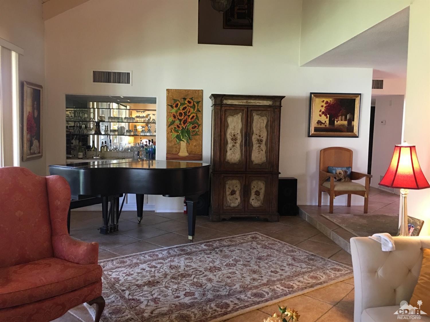 69940 Los Cocos Court Rancho Mirage, CA 92270 - Photo 7 of 37 a living room with furniture a rug and a table