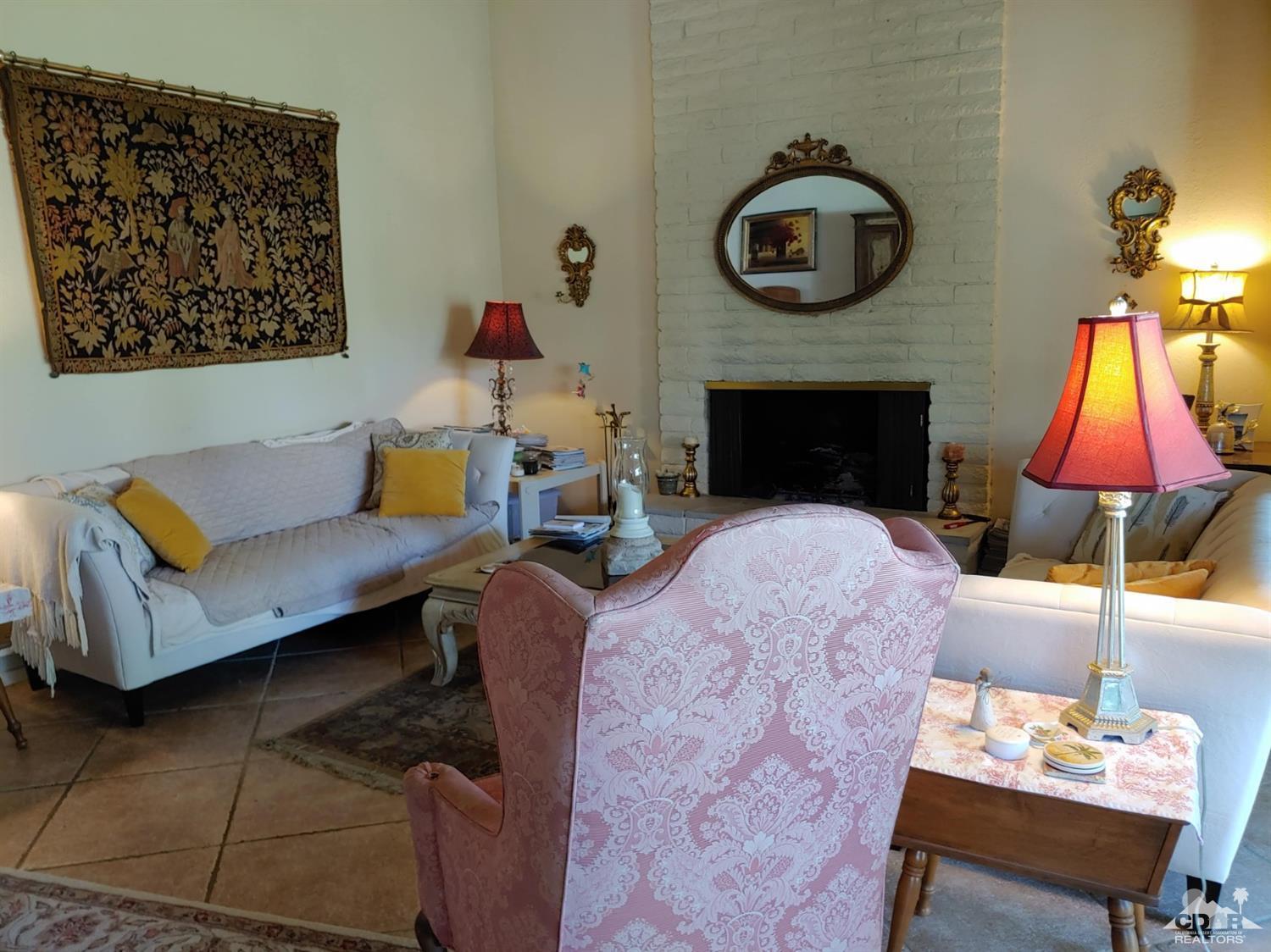 69940 Los Cocos Court Rancho Mirage, CA 92270 - Photo 8 of 37 a living room with furniture and a fireplace