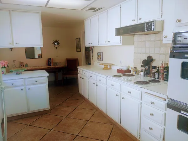 a kitchen with cabinets appliances and a sink