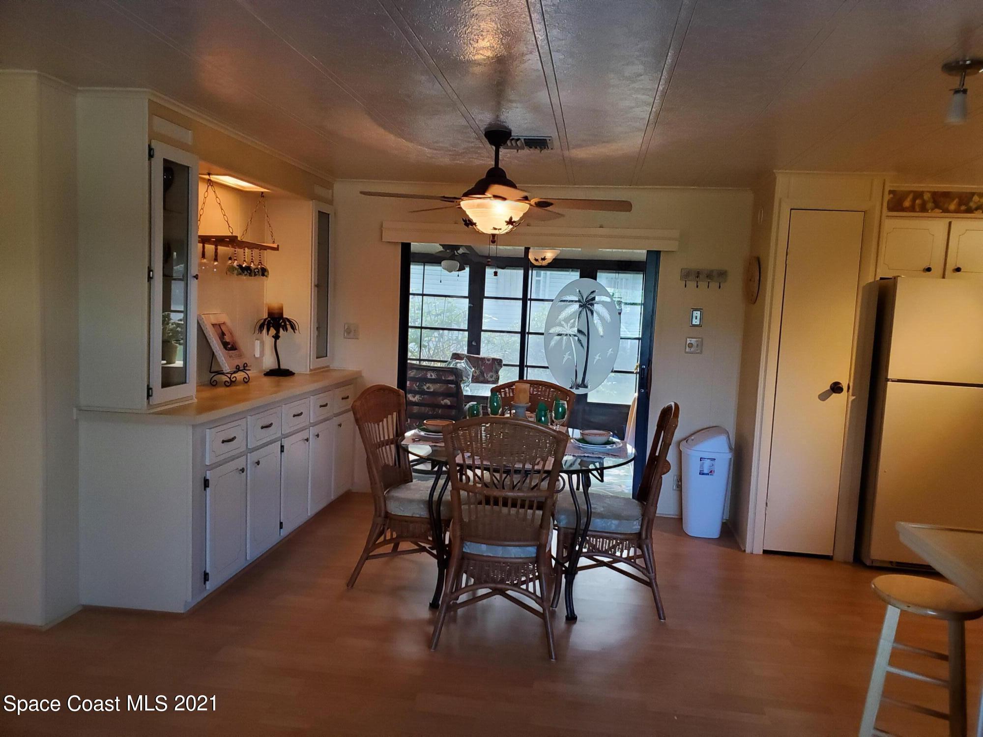 327 Macadamia Drive Sebastian, FL 32976 - Photo 11 of 31 a view of a dining room with furniture window and wooden floor