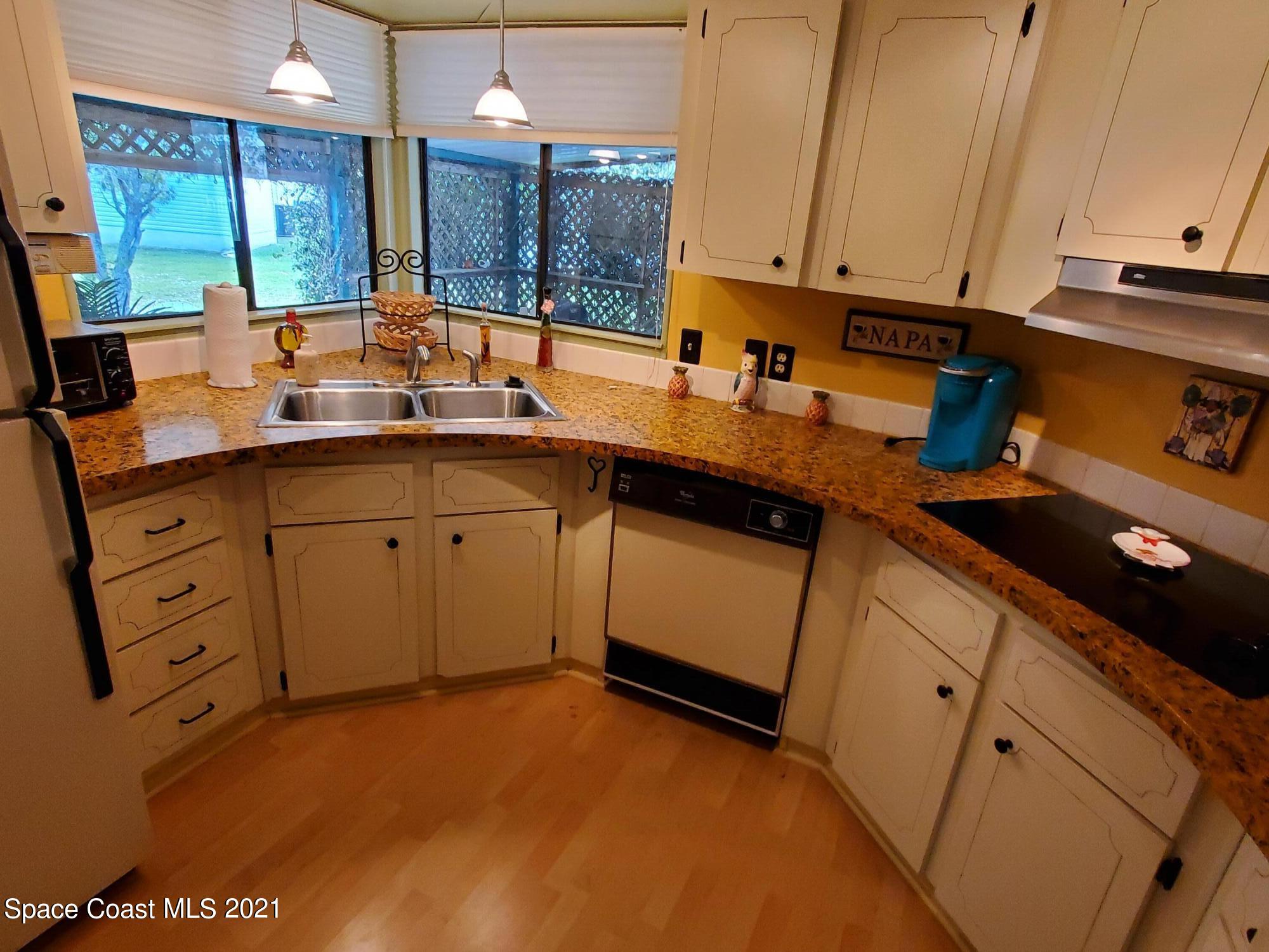 327 Macadamia Drive Sebastian, FL 32976 - Photo 15 of 31 a kitchen with appliances cabinets and a sink