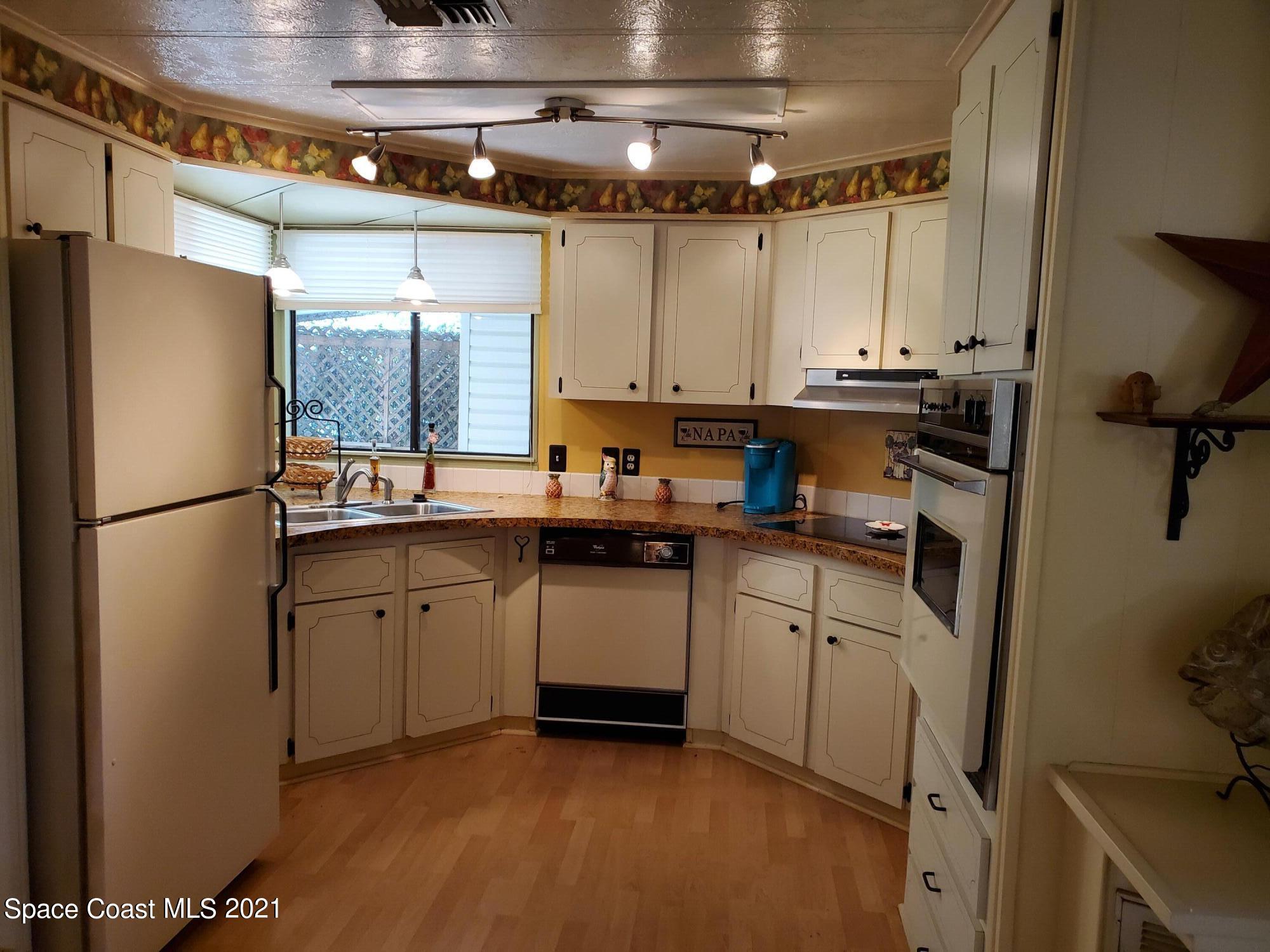 327 Macadamia Drive Sebastian, FL 32976 - Photo 16 of 31 a kitchen with a refrigerator and a sink