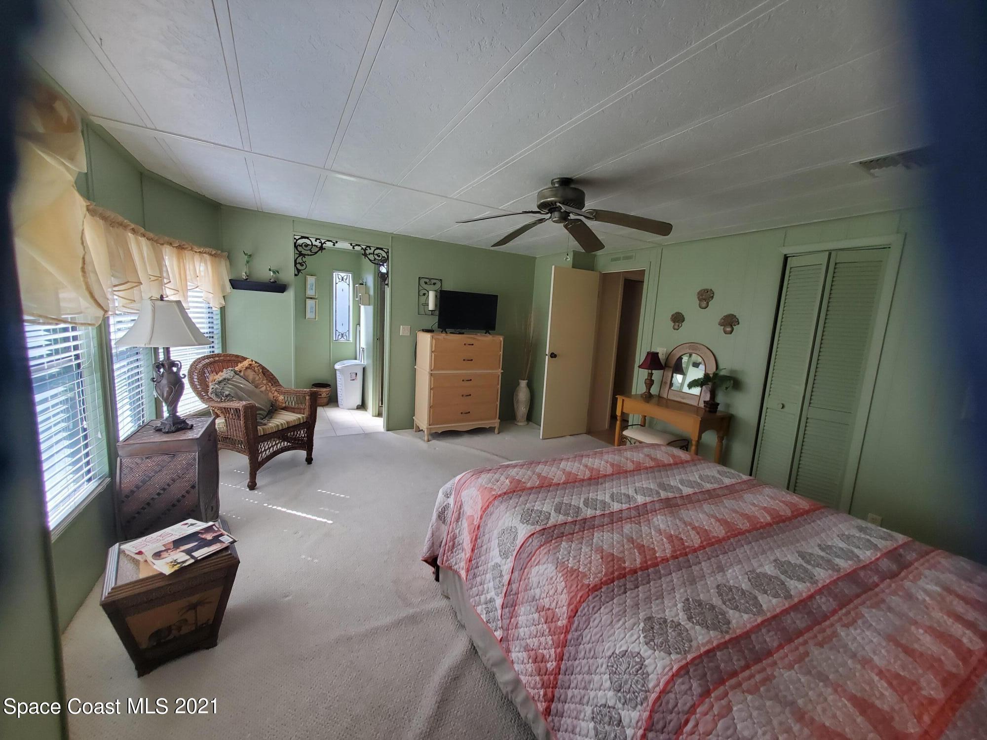 327 Macadamia Drive Sebastian, FL 32976 - Photo 18 of 31 a spacious bedroom with a bed and furniture