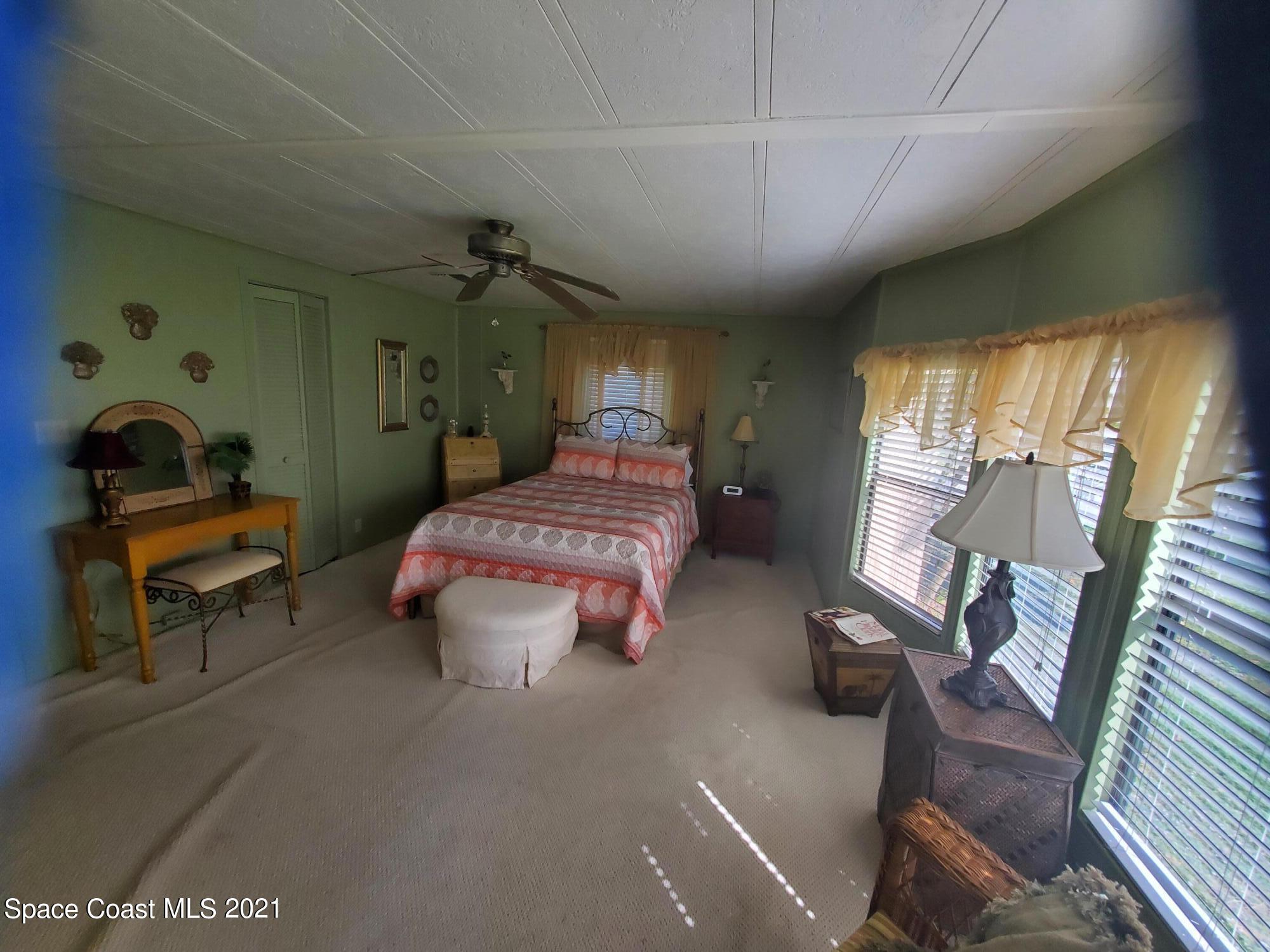 327 Macadamia Drive Sebastian, FL 32976 - Photo 19 of 31 a bedroom with furniture and a chandelier