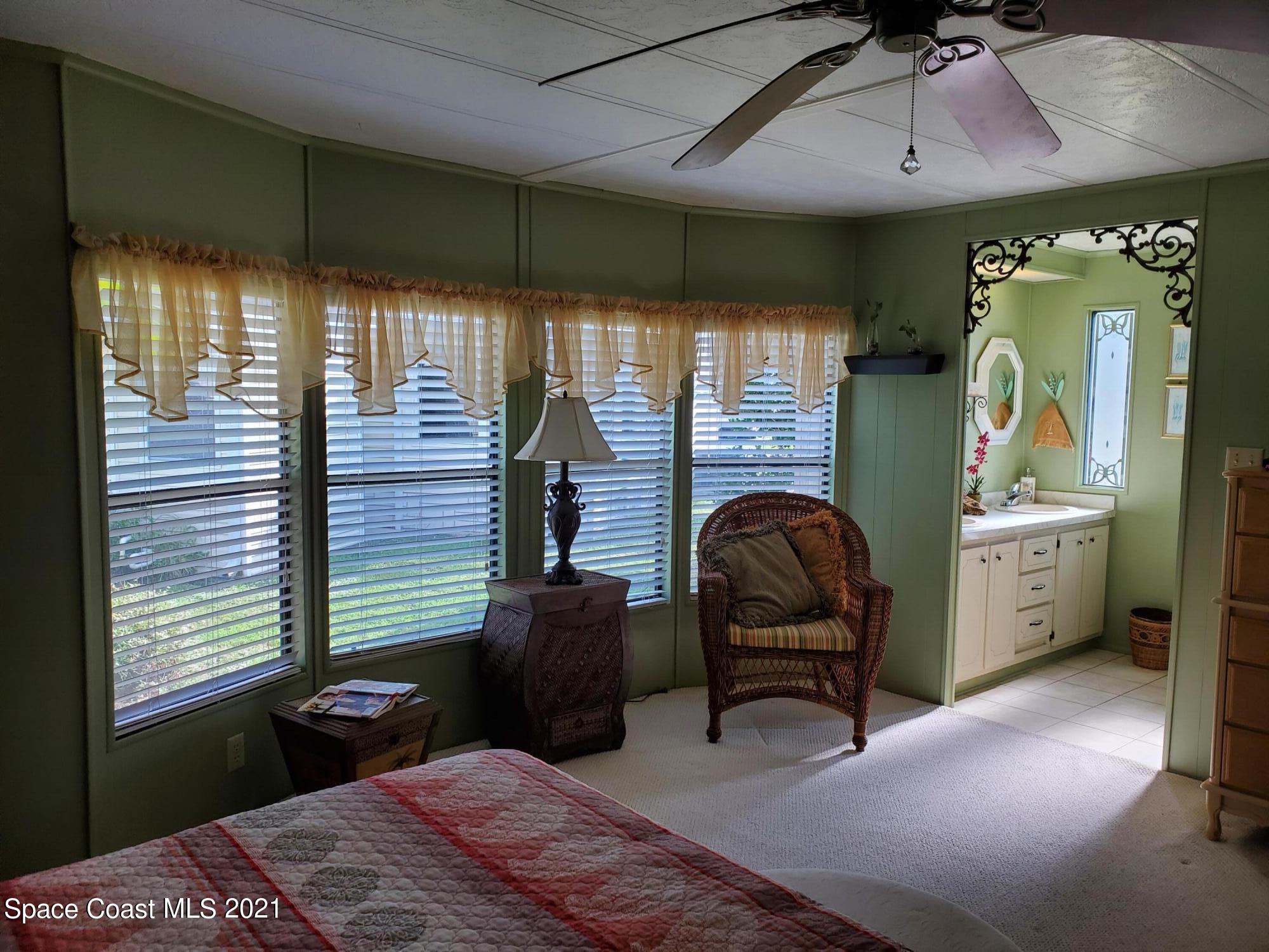 327 Macadamia Drive Sebastian, FL 32976 - Photo 20 of 31 a bedroom with a bed next to a window