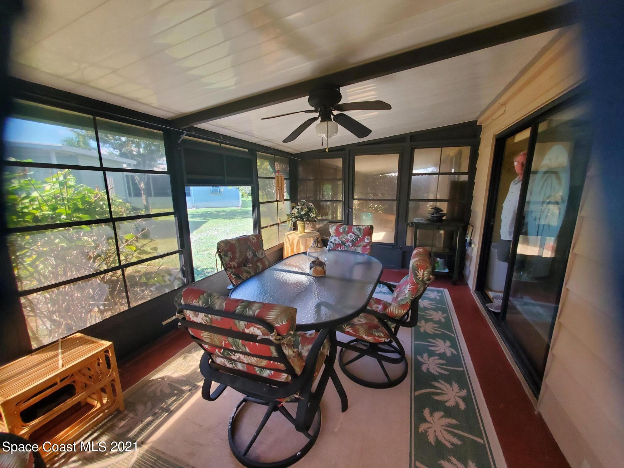 327 Macadamia Drive Sebastian, FL 32976 - Photo 2 of 31 a dining room with furniture a rug and a large window