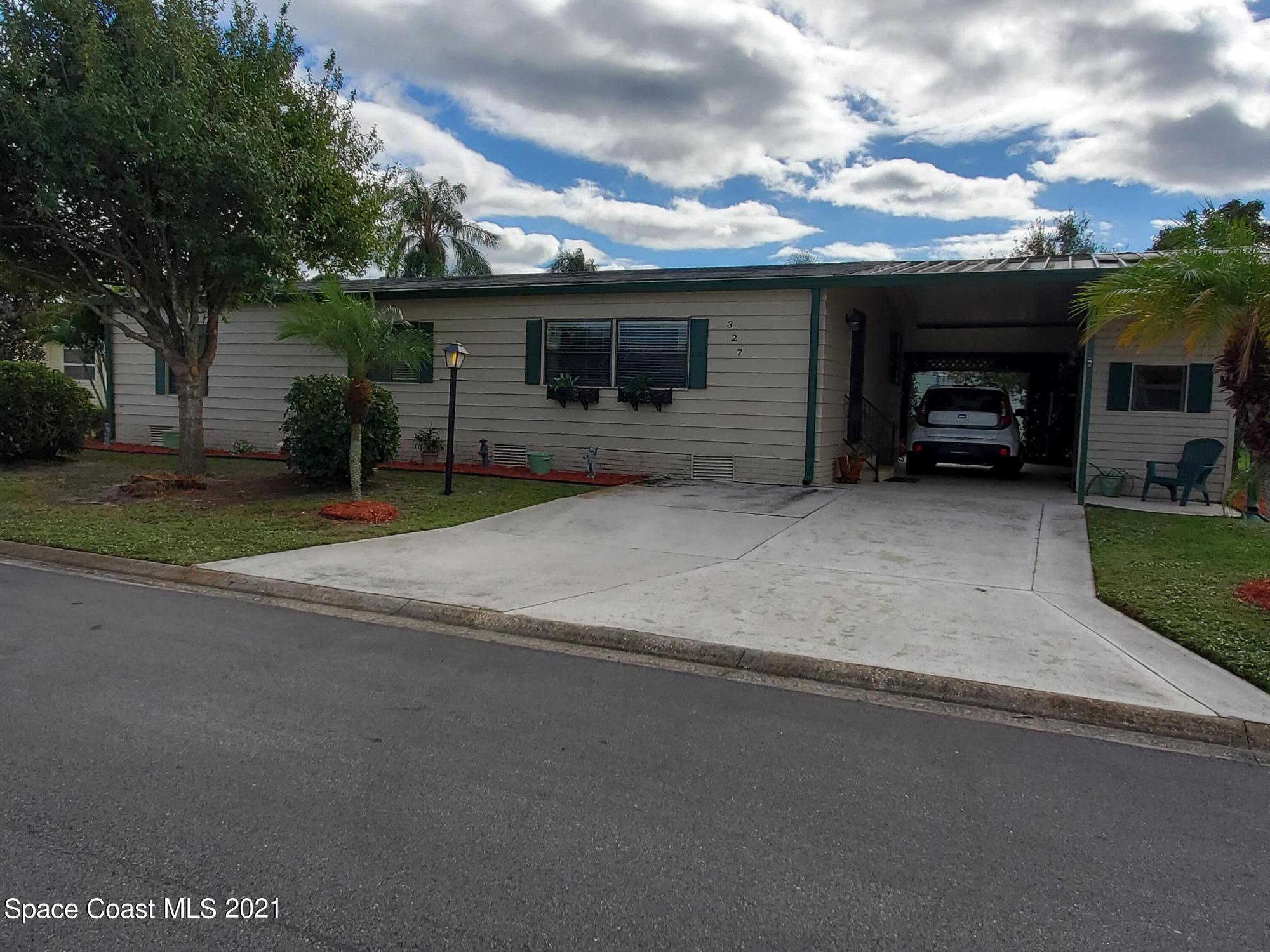 327 Macadamia Drive Sebastian, FL 32976 - Photo 28 of 31 a view of a house with a garage and a yard