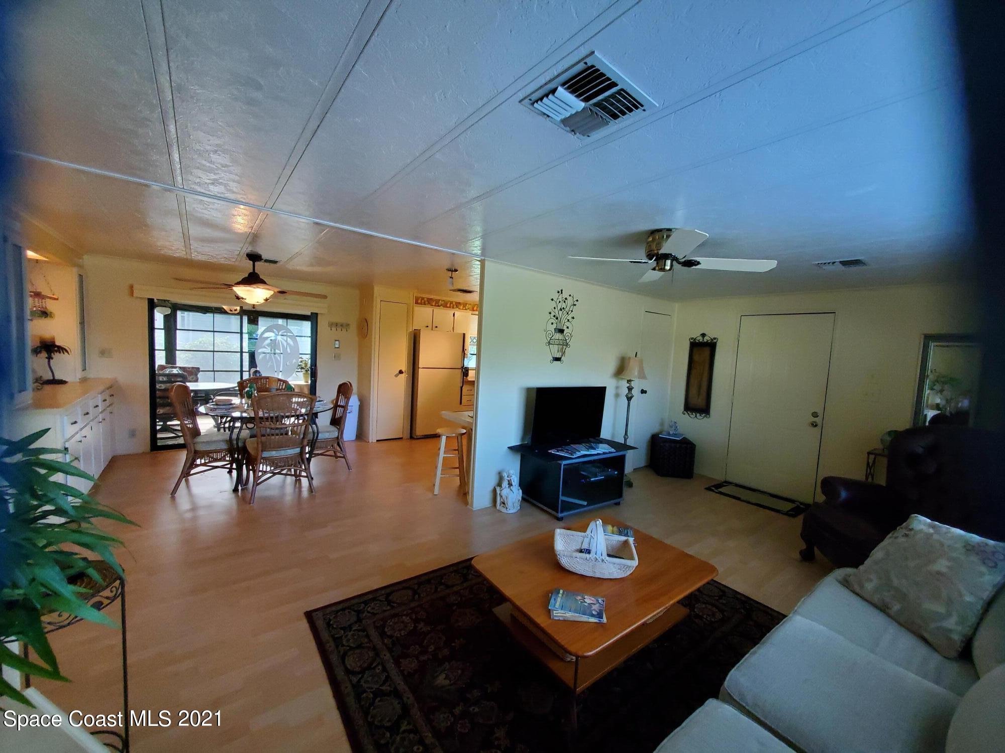 327 Macadamia Drive Sebastian, FL 32976 - Photo 4 of 31 a living room with furniture and a flat screen tv