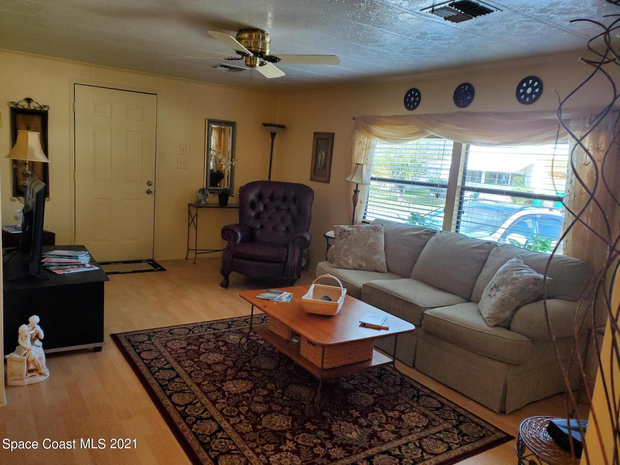 327 Macadamia Drive Sebastian, FL 32976 - Photo 5 of 31 a living room with furniture a rug and a window