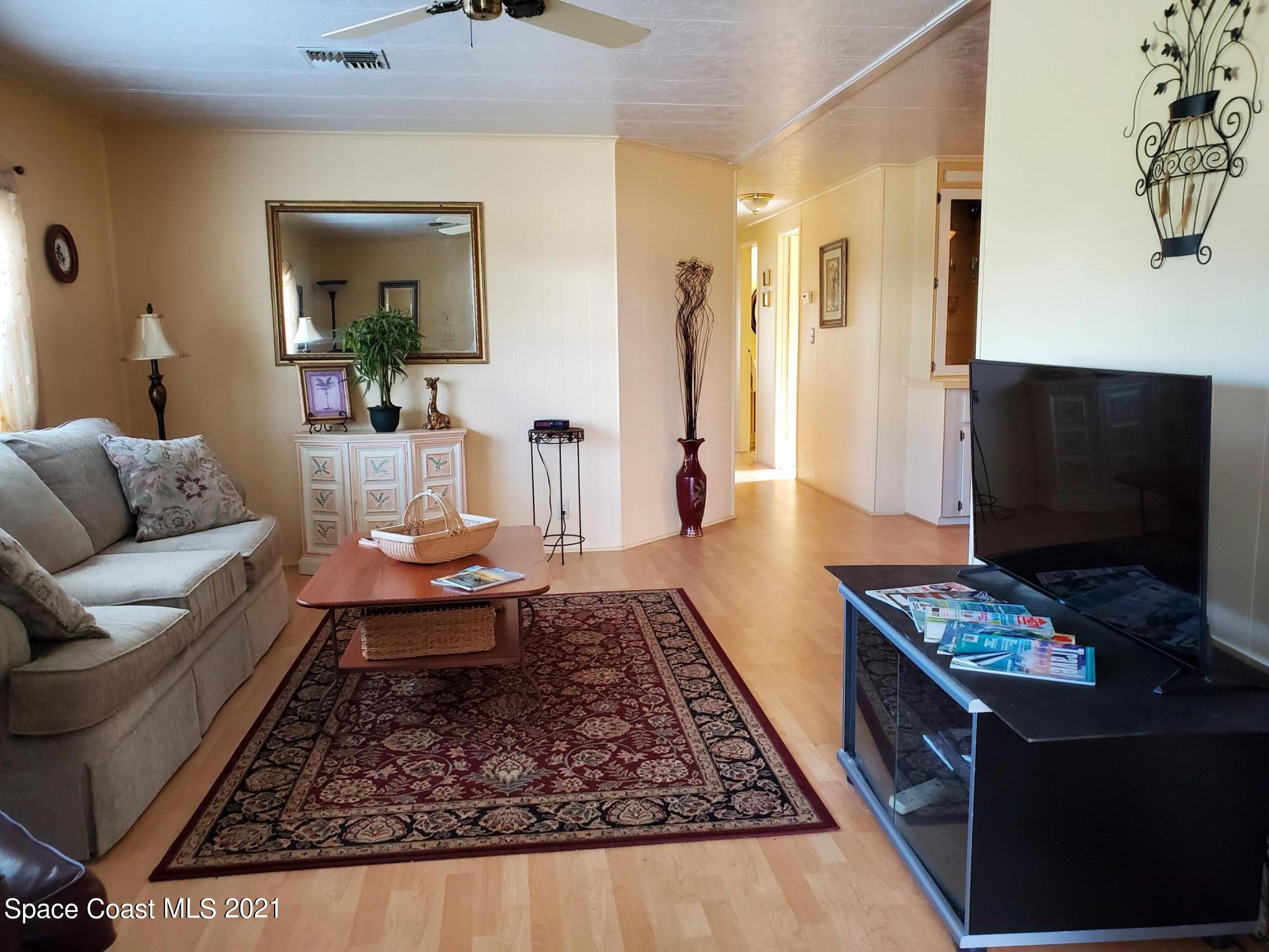 327 Macadamia Drive Sebastian, FL 32976 - Photo 6 of 31 a living room with furniture and a flat screen tv