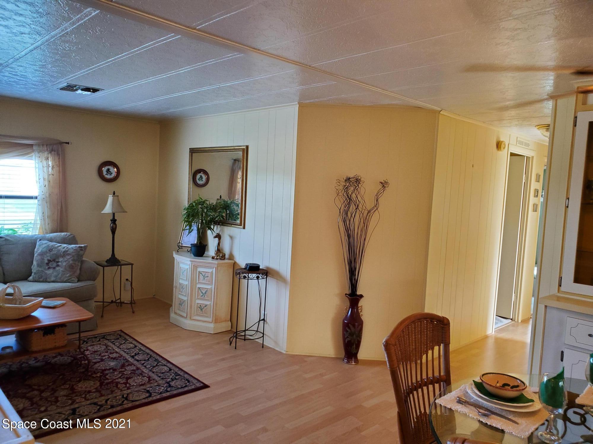 327 Macadamia Drive Sebastian, FL 32976 - Photo 7 of 31 a living room with furniture rug and a window