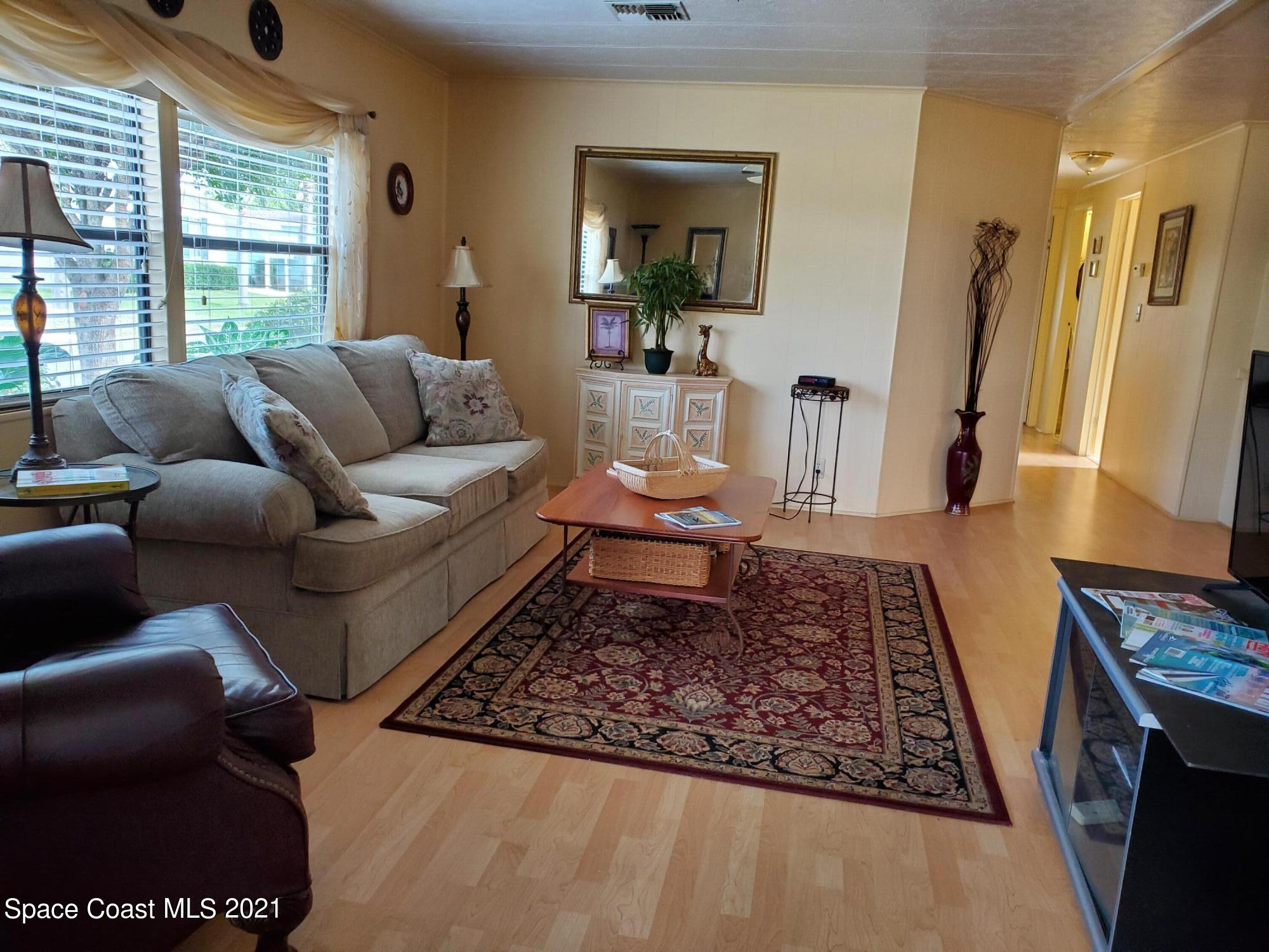 327 Macadamia Drive Sebastian, FL 32976 - Photo 8 of 31 a living room with furniture and a rug