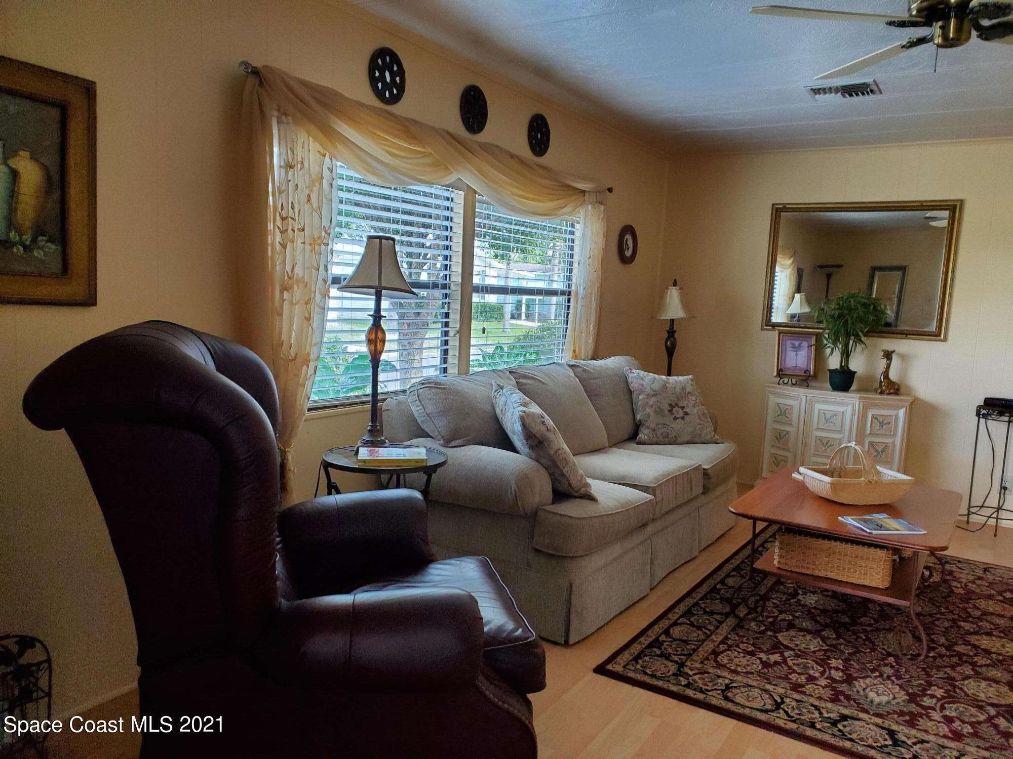 327 Macadamia Drive Sebastian, FL 32976 - Photo 9 of 31 a living room with furniture and a window