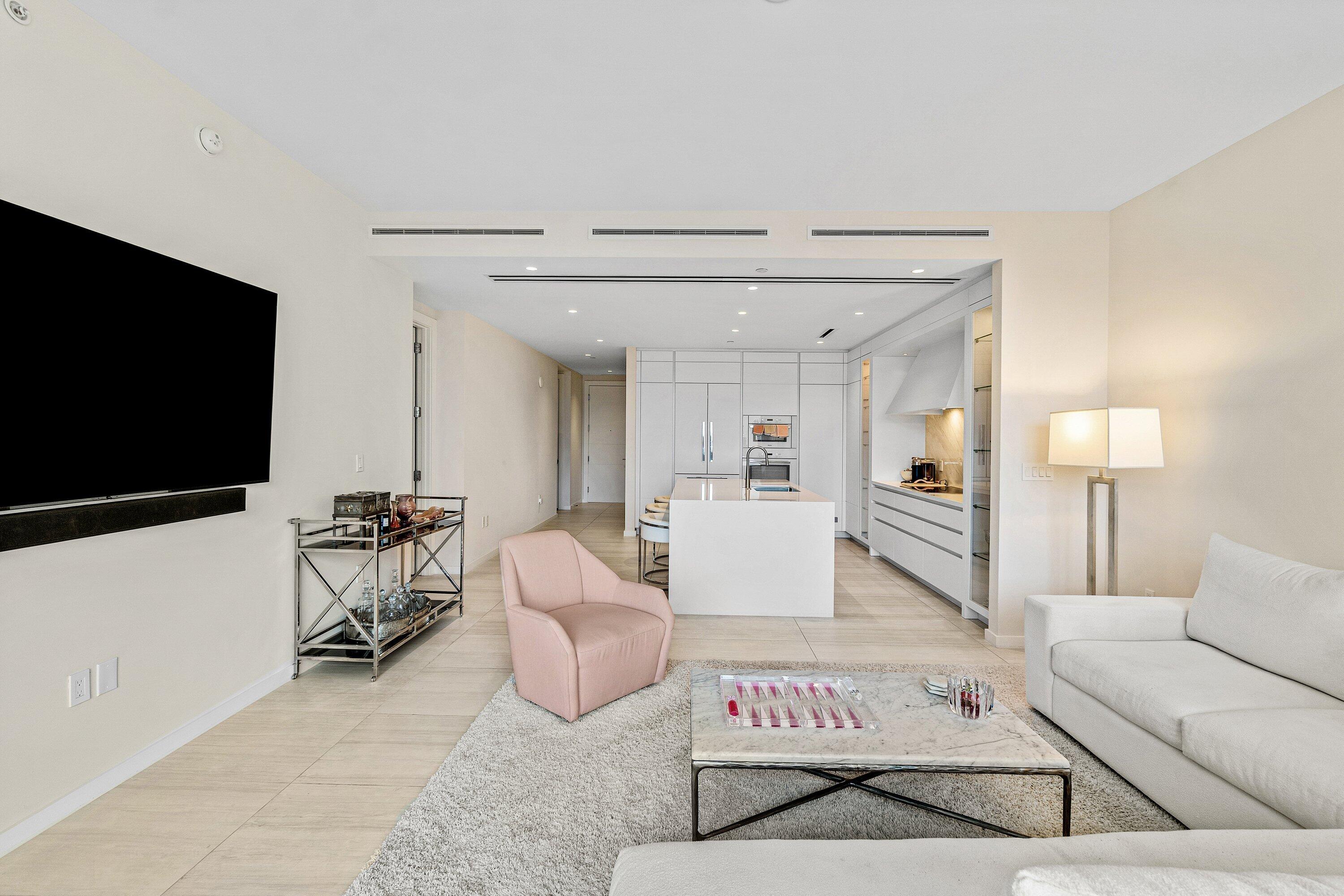 200 Southeast Mizner Boulevard, Unit 810 Boca Raton, FL 33432 - Photo 6 of 29 a living room with furniture and a flat screen tv