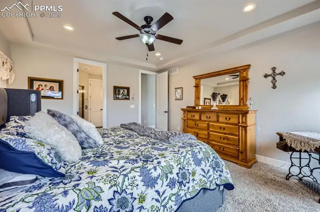 a bedroom with a bed and a dresser in it