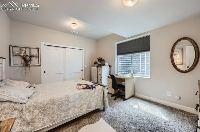 a bedroom with a bed and a chair