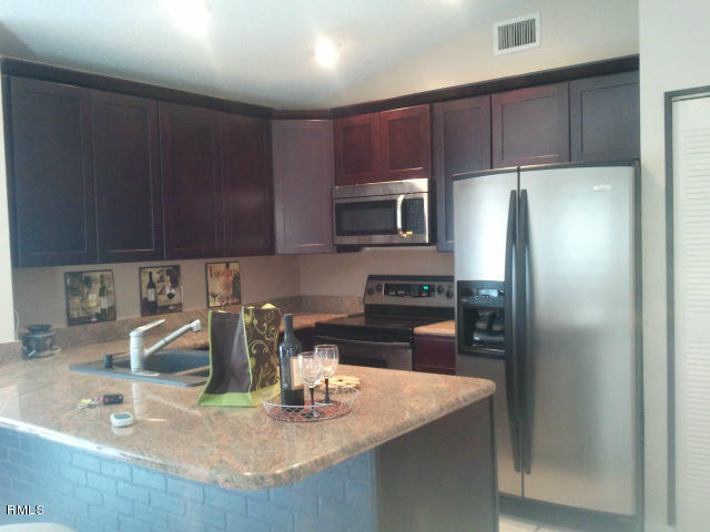 21260 Summertrace Circle Boca Raton, FL 33428 - Photo 3 of 18 a kitchen with kitchen island a refrigerator and a sink