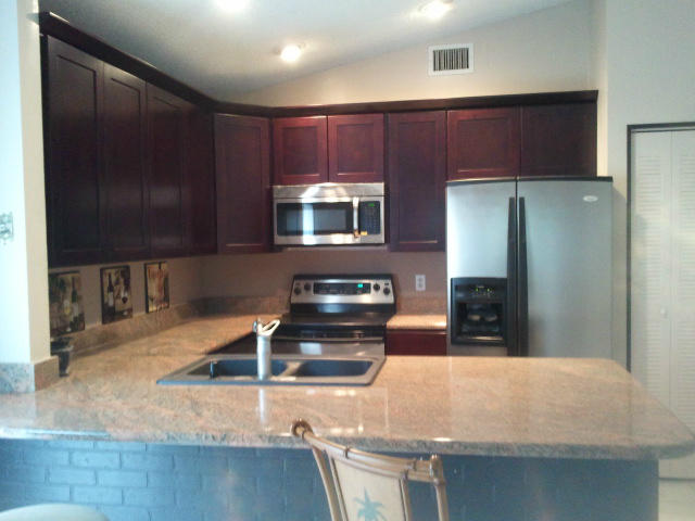 21260 Summertrace Circle Boca Raton, FL 33428 - Photo 5 of 18 a kitchen with kitchen island granite countertop a stove and a microwave