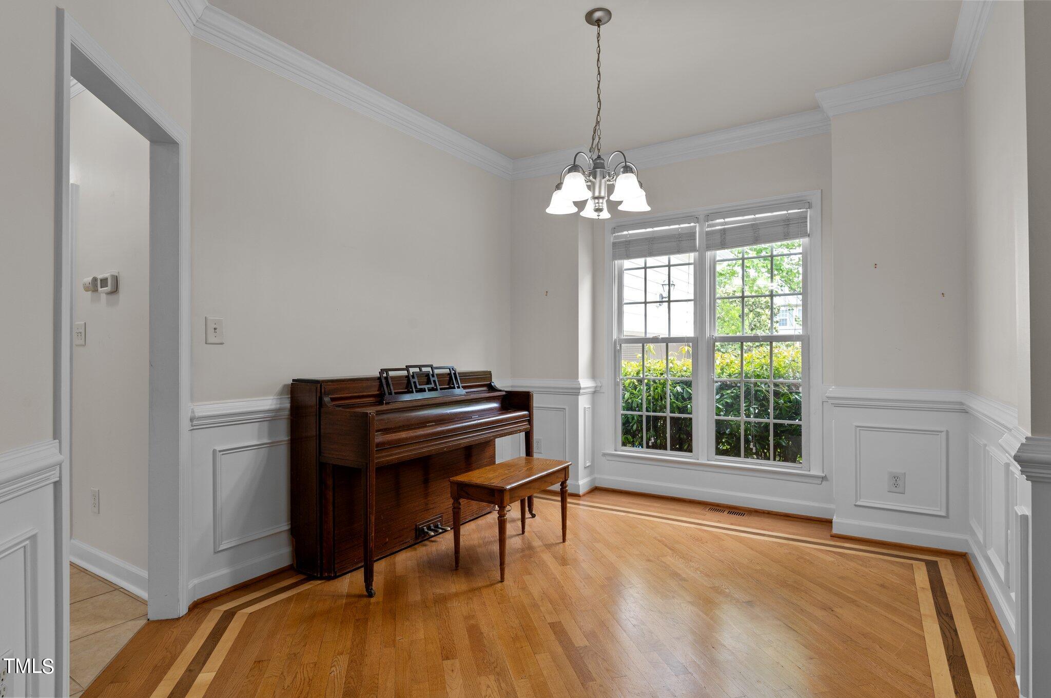 604 Middle Bridge Road Wake Forest, NC 27587 - Photo 12 of 48 a view of a livingroom with a piano and wooden floor