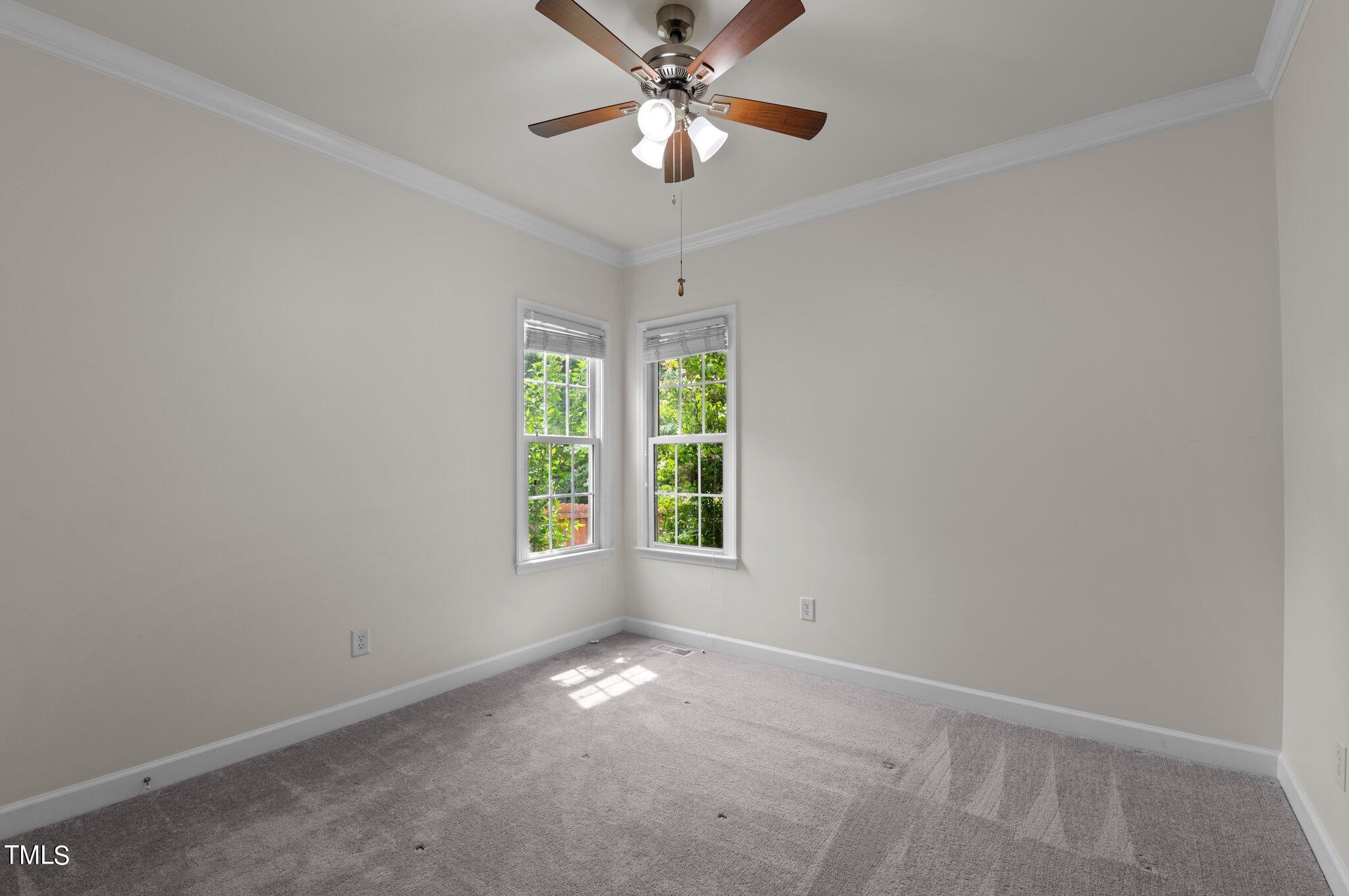 604 Middle Bridge Road Wake Forest, NC 27587 - Photo 15 of 48 an empty room with a window and a fan
