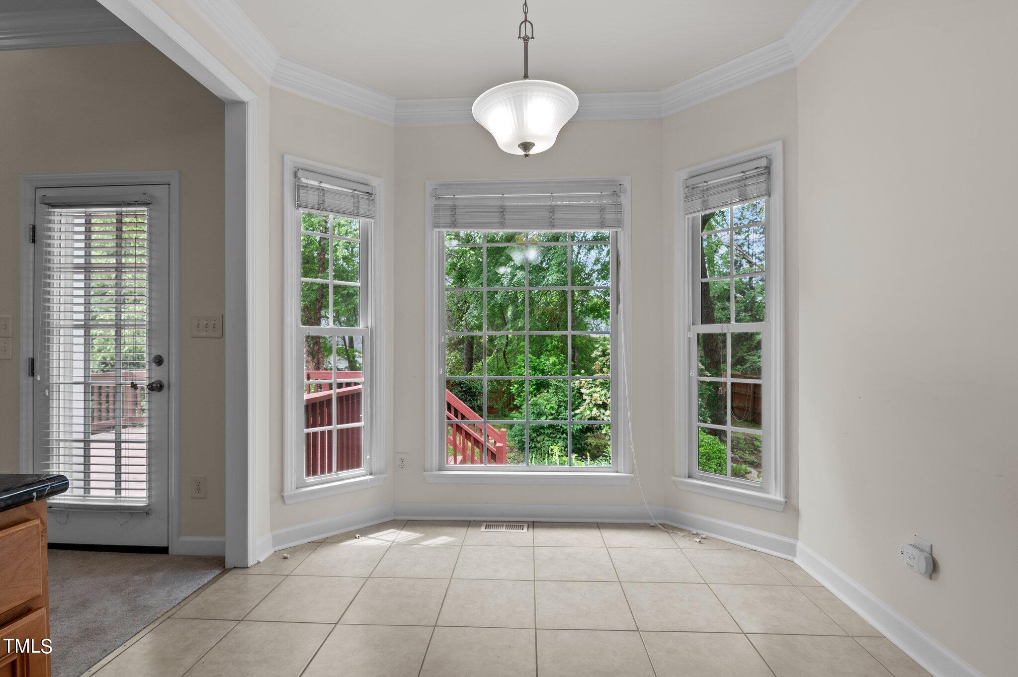 604 Middle Bridge Road Wake Forest, NC 27587 - Photo 17 of 48 a view of an empty room with windows and chandelier
