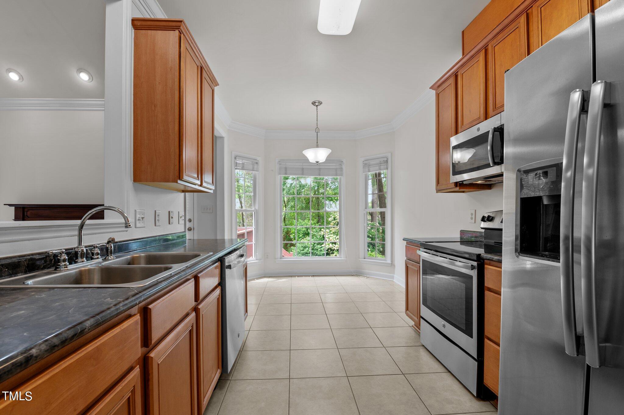 604 Middle Bridge Road Wake Forest, NC 27587 - Photo 18 of 48 a kitchen with stainless steel appliances granite countertop a sink stove and refrigerator