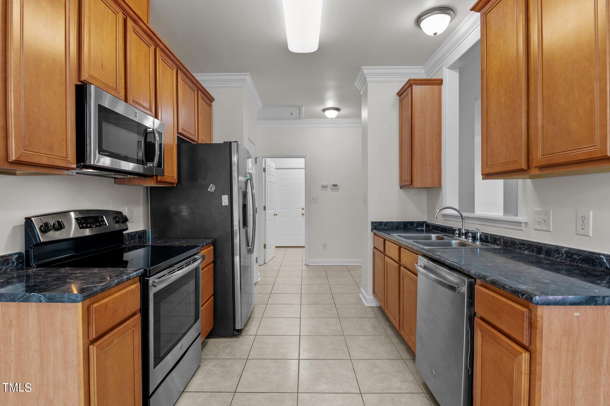 604 Middle Bridge Road Wake Forest, NC 27587 - Photo 19 of 48 a kitchen with stainless steel appliances granite countertop a stove a sink and a microwave