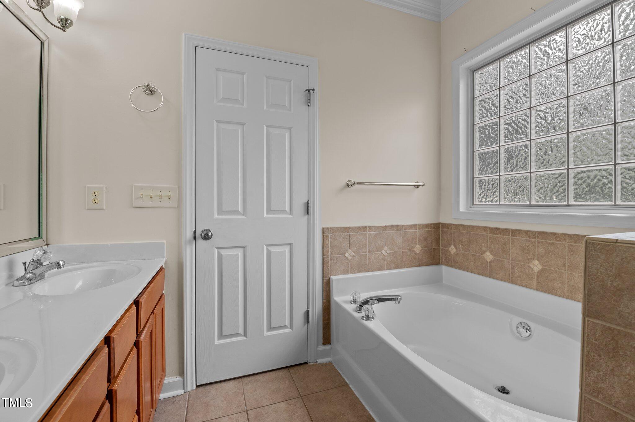 604 Middle Bridge Road Wake Forest, NC 27587 - Photo 27 of 48 a bathroom with a tub sink and a mirror