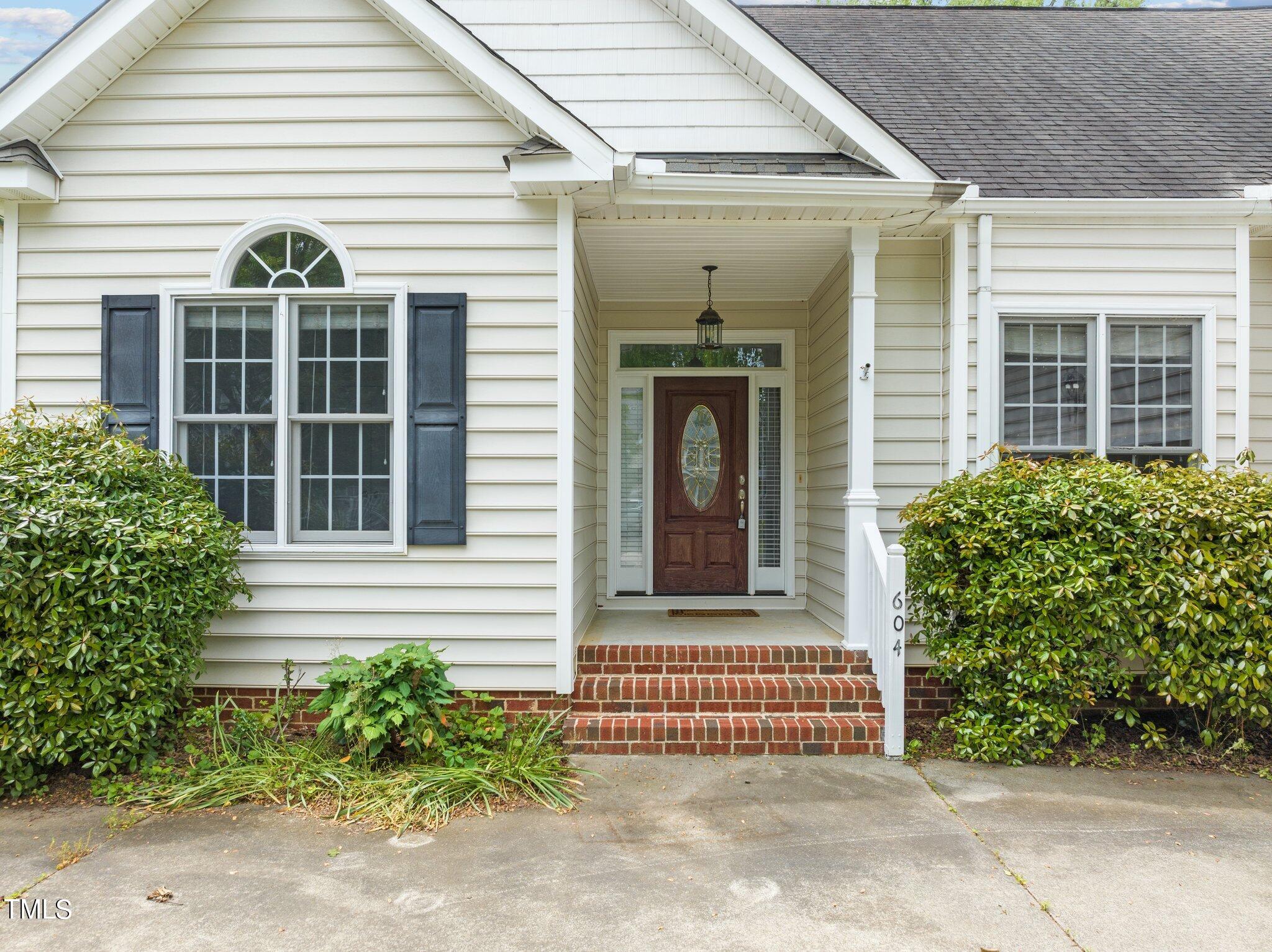 604 Middle Bridge Road Wake Forest, NC 27587 - Photo 5 of 48 a front view of a house with a garden