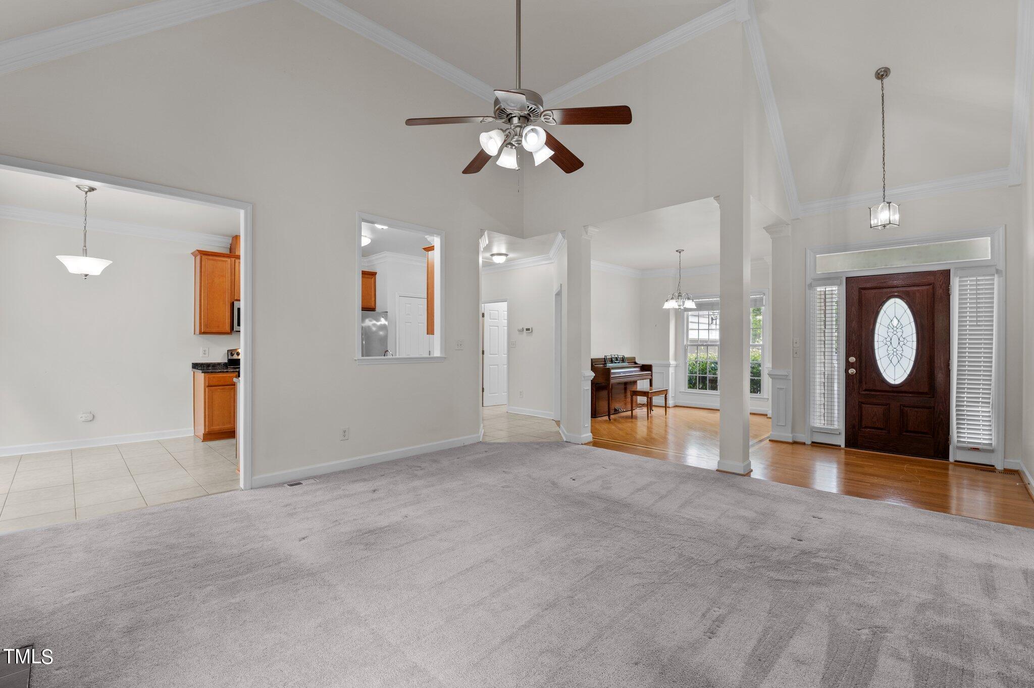 604 Middle Bridge Road Wake Forest, NC 27587 - Photo 8 of 48 a view of a livingroom with a ceiling fan and kitchen view