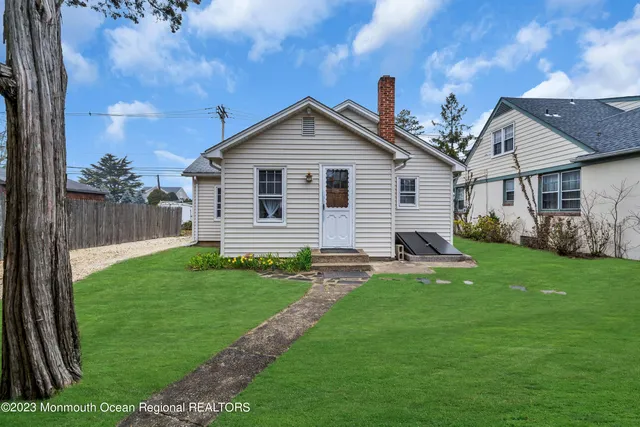 a view of backyard of house with green space