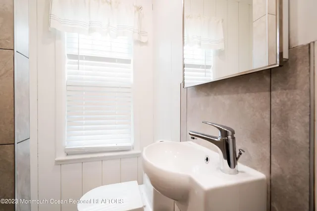 a bathroom with a sink and a window