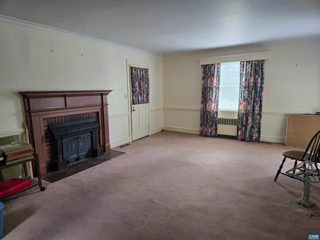 a view of a livingroom with furniture and a fireplace