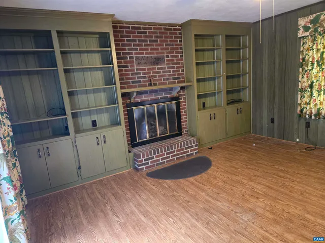 a view of wooden floor and windows in a room