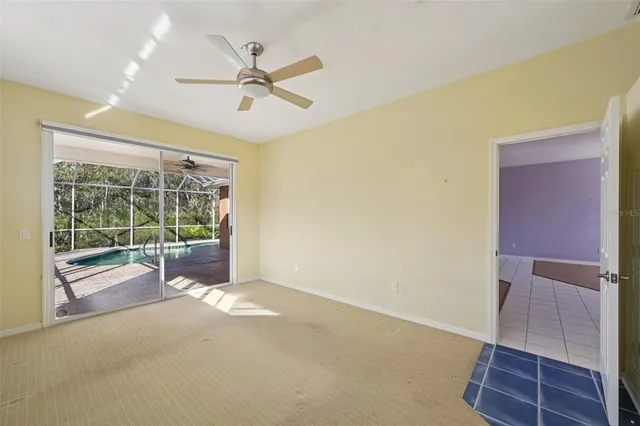 a view of a livingroom with a ceiling fan and window