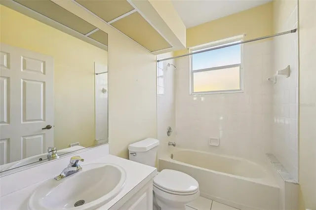 a bathroom with a sink mirror toilet and bathtub