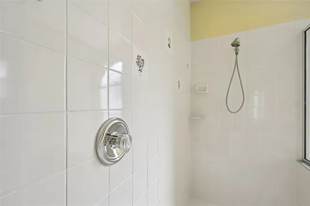 a bathroom with a granite countertop shower and a sink