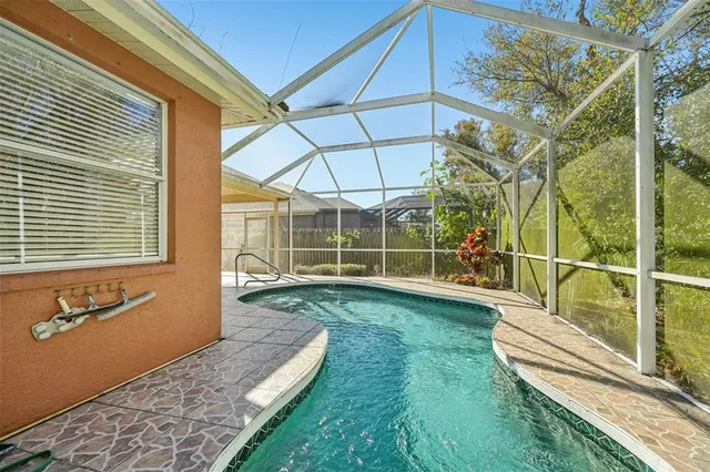 a view of a backyard with wooden floor and iron fence