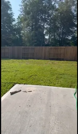 a view of a backyard with grass