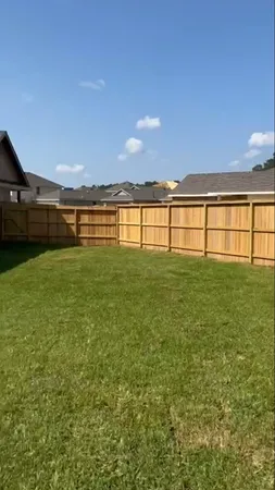 a big room with yard and large trees