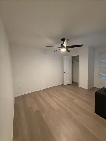 a view of an empty room with a ceiling fan
