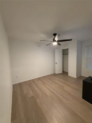 a view of an empty room with a ceiling fan
